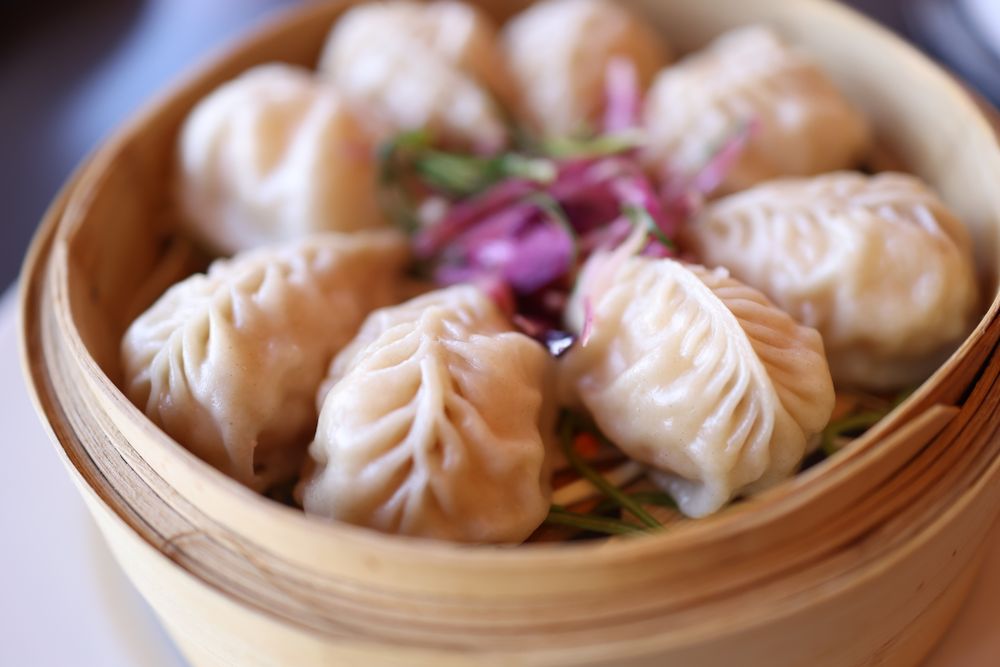 Har gow prawn dumplings in a yellow bamboo basket